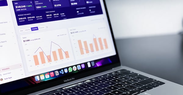 A laptop with a graph on the screen.